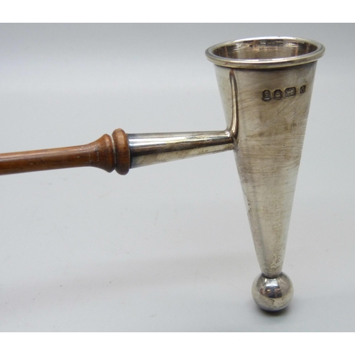 822 - A silver candle snuffer, London 1979, 25cm