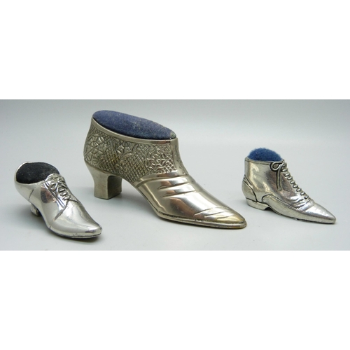 829 - Three novelty pewter pin cushion shoes