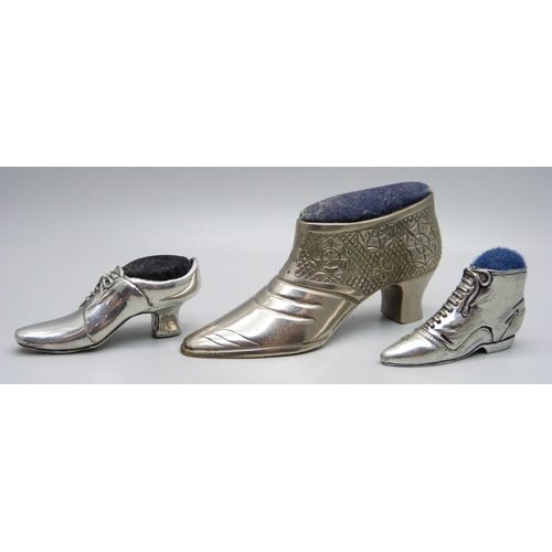 829 - Three novelty pewter pin cushion shoes