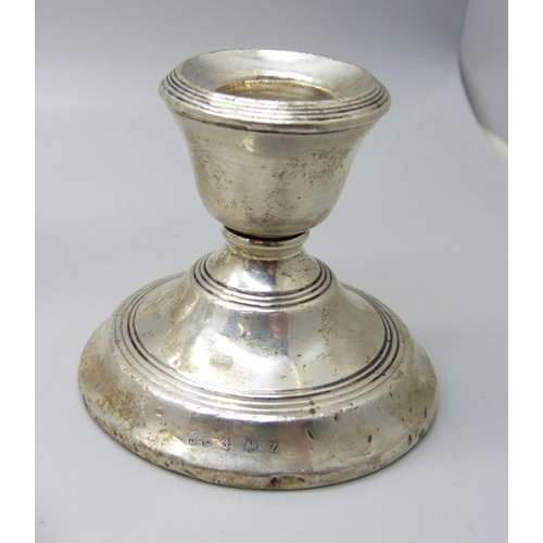 835 - Two pairs of silver sugar bows, a silver candlestick, a sterling sifter spoon and other silver mount... 