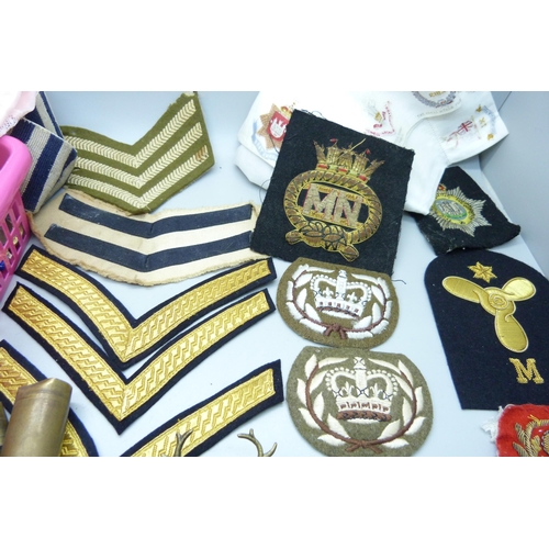 838 - Militaria; cloth badges, handkerchief, metal soldiers, uniform buttons, badges, leather pouch, etc.