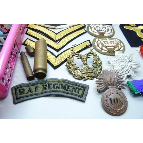 838 - Militaria; cloth badges, handkerchief, metal soldiers, uniform buttons, badges, leather pouch, etc.