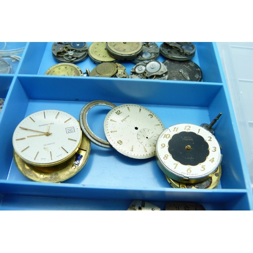 878 - A collection of watch movements and dials including Omega