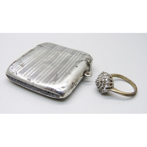 907 - A silver vesta case, Birmingham 1922, and a cluster ring, O