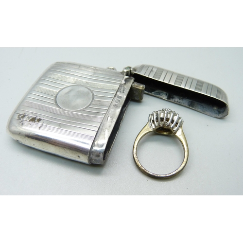 907 - A silver vesta case, Birmingham 1922, and a cluster ring, O