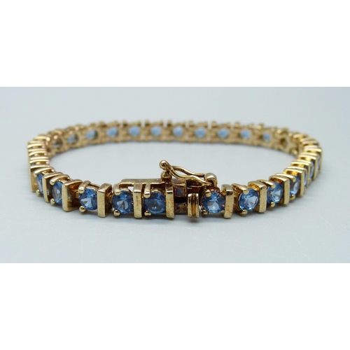 916 - A silver gilt and topaz line bracelet