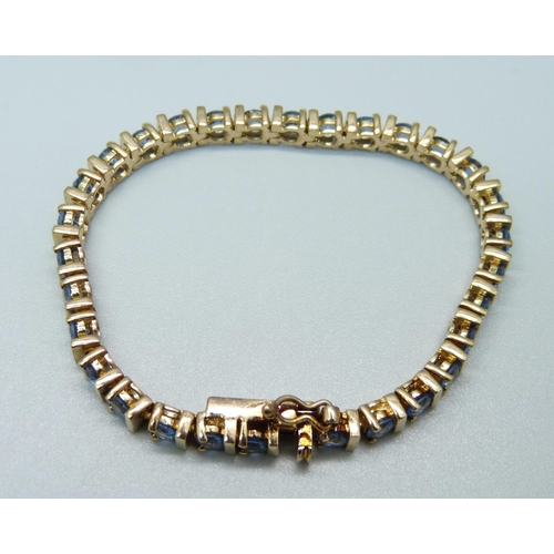 916 - A silver gilt and topaz line bracelet