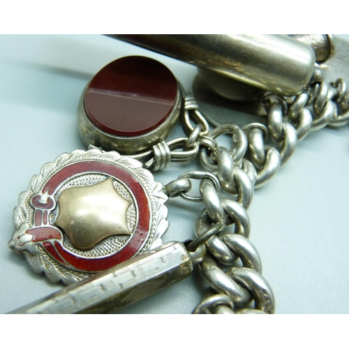 960 - A silver charm bracelet, with Victorian silver swivel fob, a hallmarked Victorian silver violin char... 