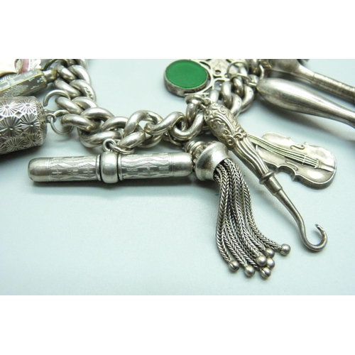 960 - A silver charm bracelet, with Victorian silver swivel fob, a hallmarked Victorian silver violin char... 