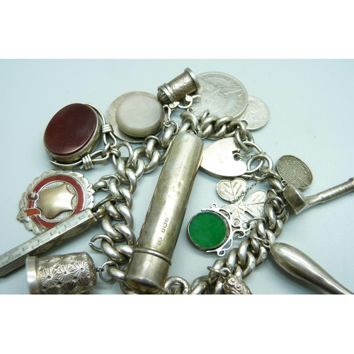 960 - A silver charm bracelet, with Victorian silver swivel fob, a hallmarked Victorian silver violin char... 