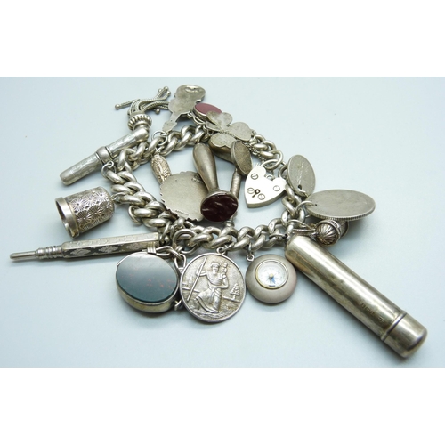 960 - A silver charm bracelet, with Victorian silver swivel fob, a hallmarked Victorian silver violin char... 