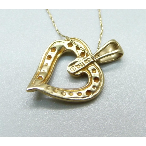 985 - A 10k heart shaped pendant on a fine 10k gold chain, 1.8g