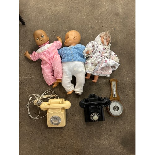 2449 - A box of vintage items including telephones, barometer and 3 dolls