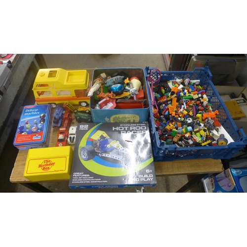 2083 - A box of toys inc. deluxe marbles, hot rod racer Lego, and toy cars