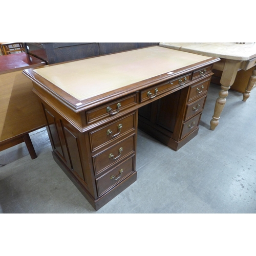 107 - A Victorian style mahogany and leather topped pedestal desk