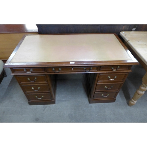 107 - A Victorian style mahogany and leather topped pedestal desk