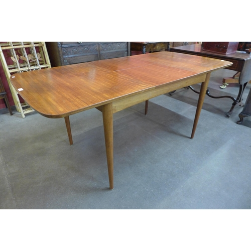 13 - An Austin Suite teak extending dining table