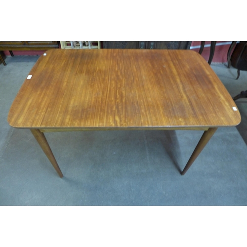 13 - An Austin Suite teak extending dining table