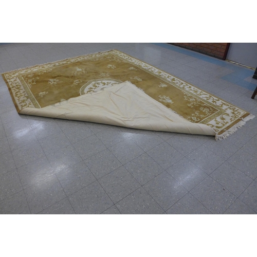 156 - A large Chinese beige ground rug, 277 x 380cms