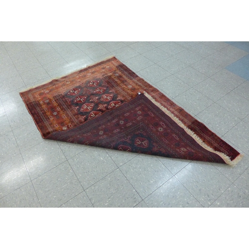 159 - An eastern red ground rug, 123 x 194cms