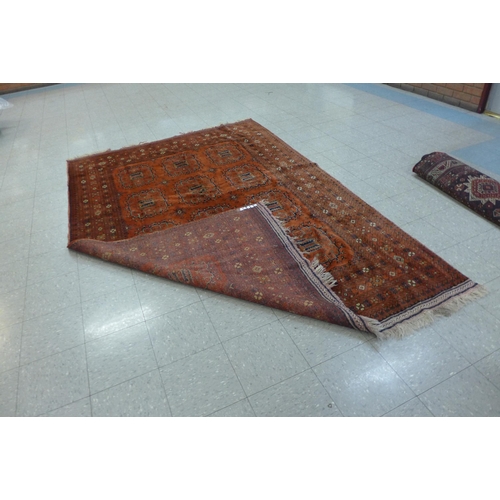 160 - An eastern terracotta ground rug, 200 x 306cms