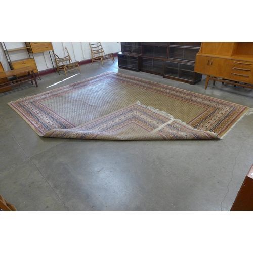 165 - A large beige ground  rug, 301 x 393cms