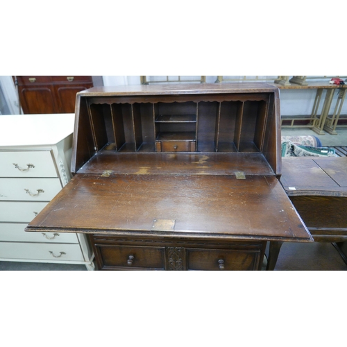 201 - A carved oak bureau and an oak sewing box