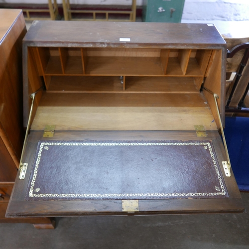 203 - An Art Deco walnut tallboy and a carved oak bureau