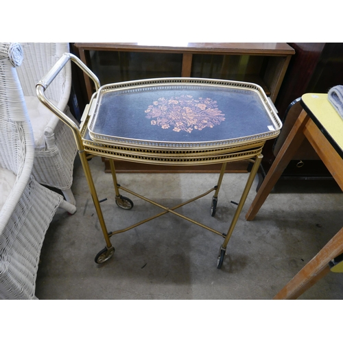 209 - A teak bookcase, a Stag Minstrel mahogany tallboy, a brass two tier drinks trolley and a rug