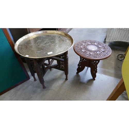 211 - An Indian brass topped folding occasional table, another Indian occasional table and an early 20th C... 