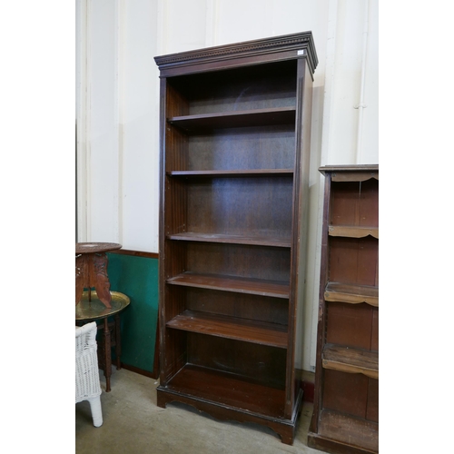 212 - A tall mahogany open bookcase and one other