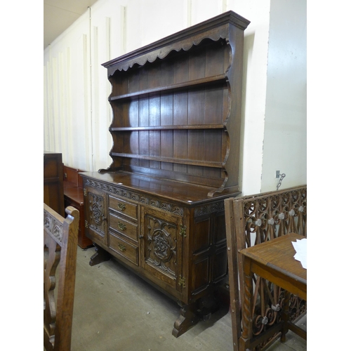 213 - An oak refectory table, seven chairs and a dresser