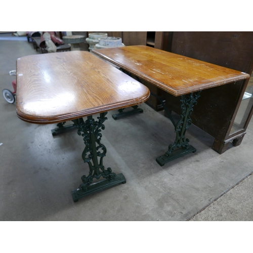 221 - A pair of similar cast iron and oak topped pub tables