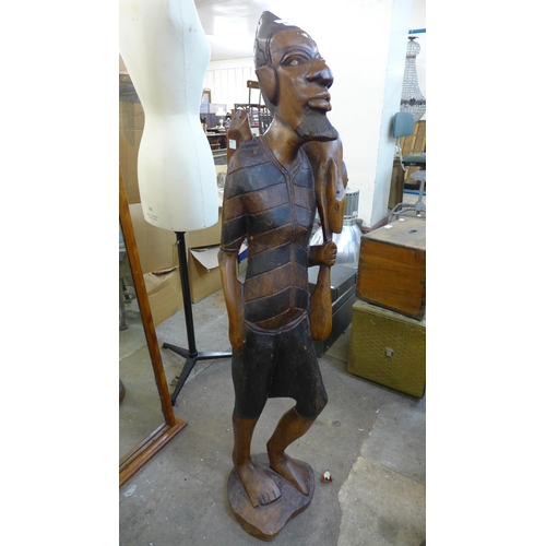 245 - An African carved hardwood figure of a huntsman