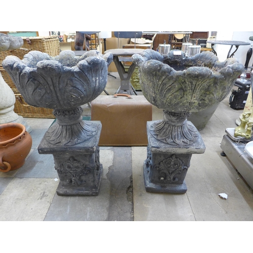 255 - A pair of concrete planters on pedestals