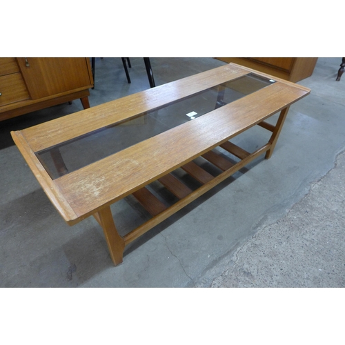 26 - A teak and glass topped rectangular coffee table