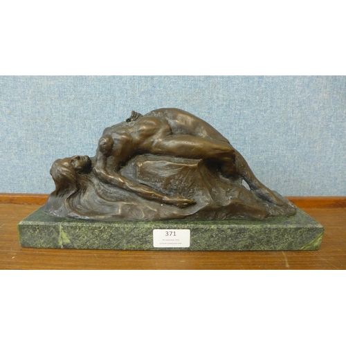 371 - An Art Deco style bronze figure of a reclining female nude on a rock, on black marble socle