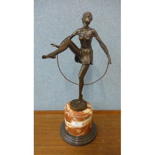 380 - An Art Deco style bronze figure of a female hoop dancer, on rouge marble socle