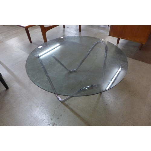 49 - A chrome and smoked glass topped circular coffee table