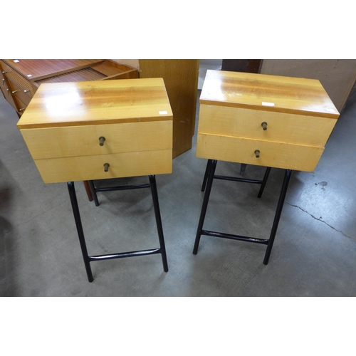 52 - A pair of birch two drawer chests on black tubular metal stands