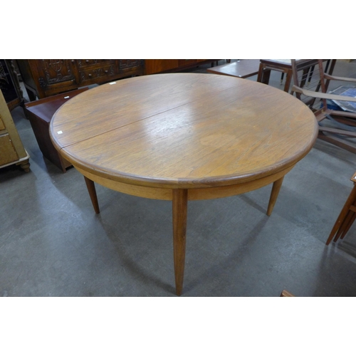 59 - A G-Plan Fresco teak circular extending dining table