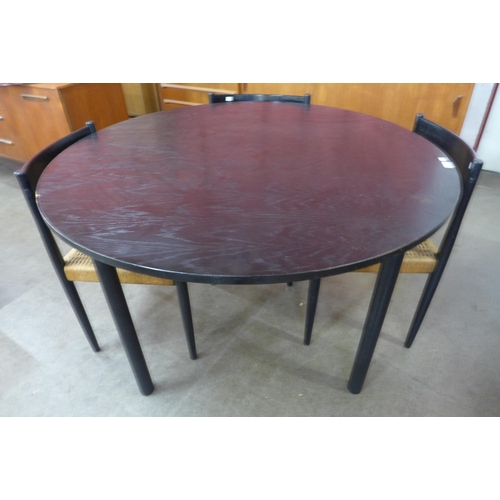 6 - A Danish Frem Rojle black ash circular dining table and four chairs