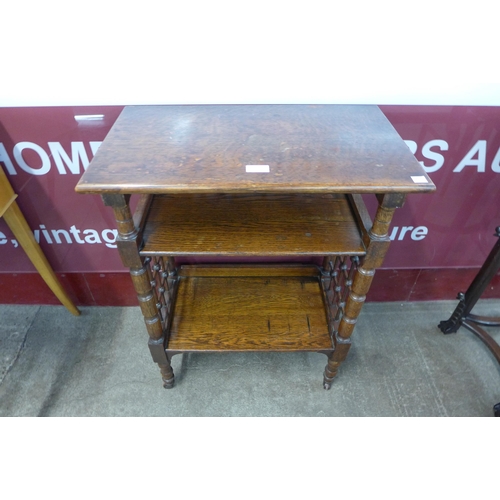 70 - An Arts and Crafts Liberty & Co. oak reading stand, designed by Leonard Wyburd