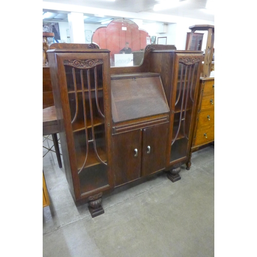 83 - A carved oak side by side bureau bookcase