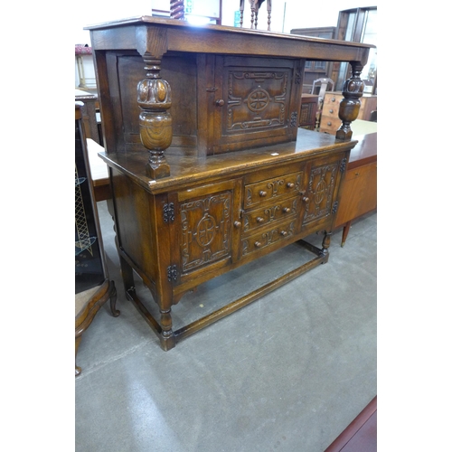 96 - A 17th Century style carved oak court cupboard