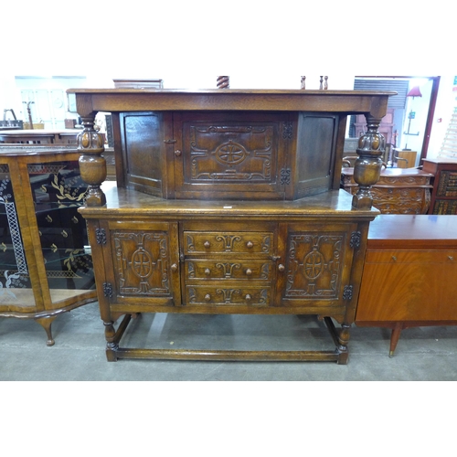 96 - A 17th Century style carved oak court cupboard