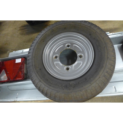 2470 - Trailer parts including hinged doors, a trailer wheel and a wheelbarrow wheel