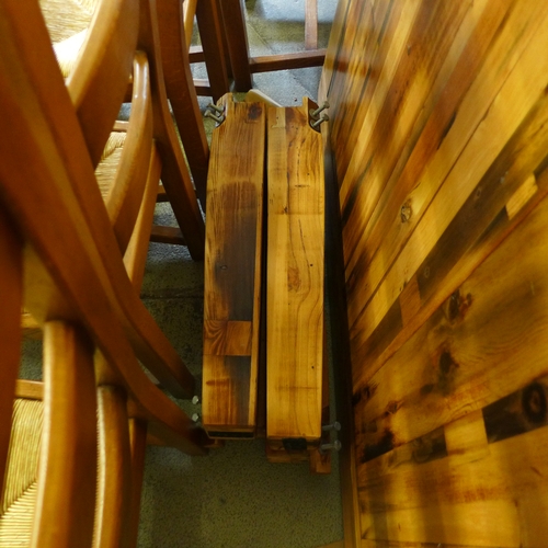 1521 - A large rustic dining table and eight oak ladderback chairs