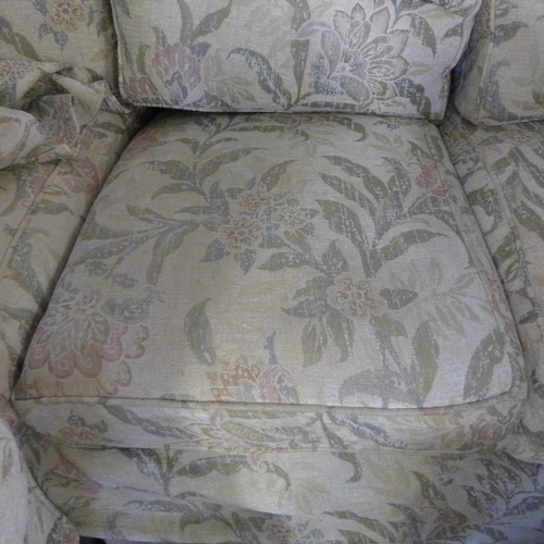 1548 - A Multiyork cream floral upholstered three seater sofa and a pair of matching armchairs