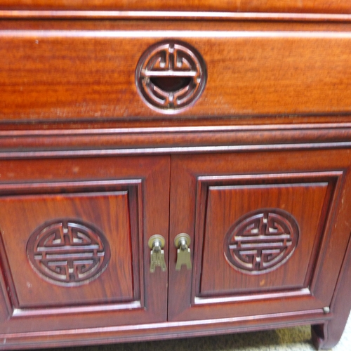 1556 - An oriental mahogany two door, single drawer cabinet